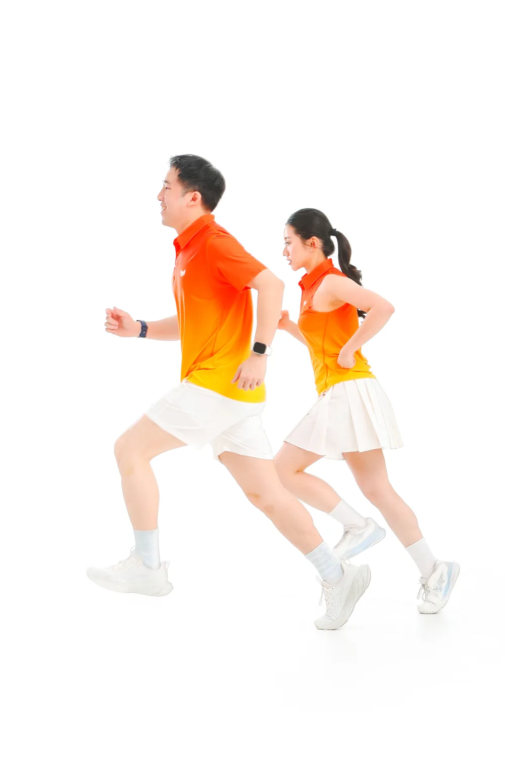 A man and a woman running side by side in Ember Fade tops